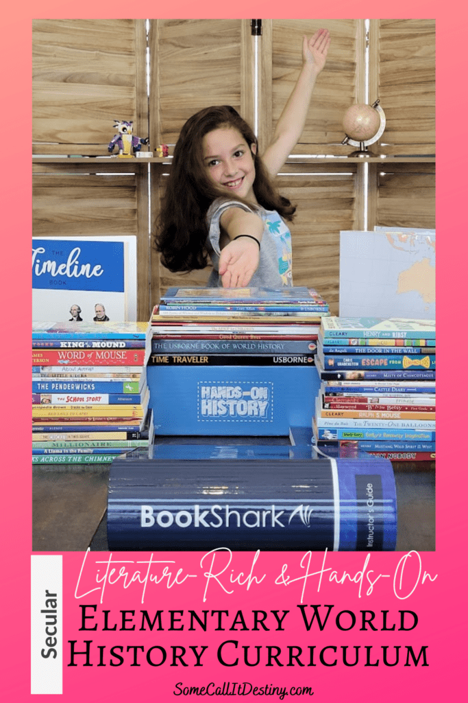 little girl showing off all the books in the BookShark World History II, Reading with History C curriculum