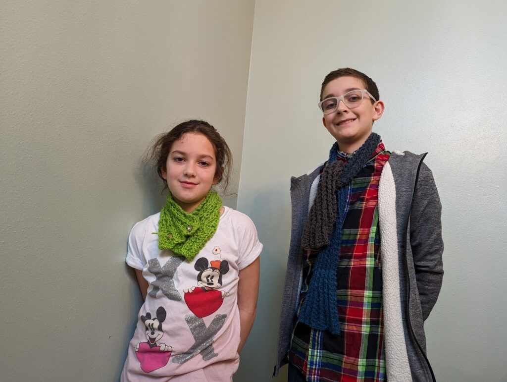 boy and girl wearing knitted scarves