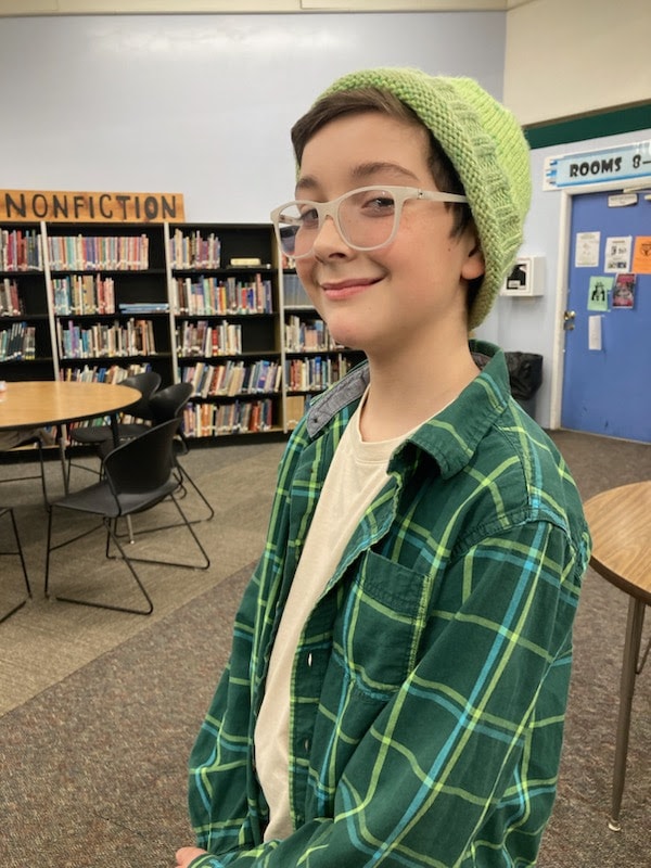 boy wearing green beanie he knitted
